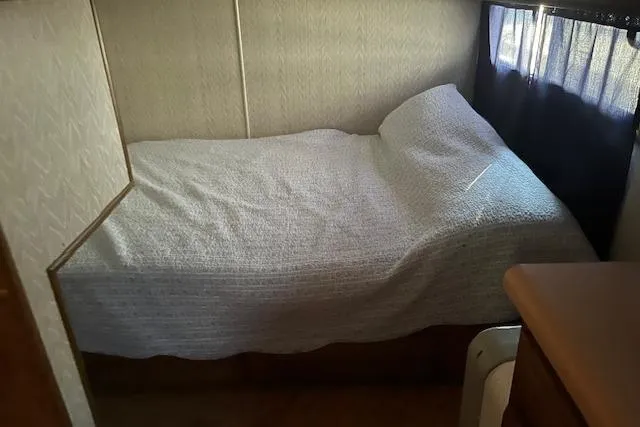 Slide: The Image of Cozy bedroom in 1992 Jamestowner 16x72 houseboat with simple bedding and natural light. - 13