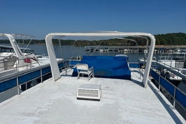 Slide: The Image of 1992 Jamestowner 16x72 houseboat deck with seating, overlooking a serene lake view. - 20
