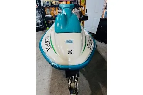Slide: The Image of 1994 Sea-Doo SPX jet ski in a garage, featuring a blue and white design. - 3