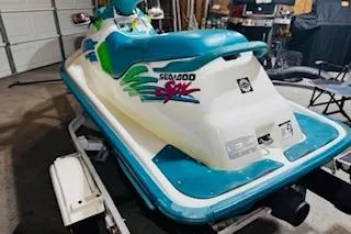Slide: The Image of 1994 Sea-Doo SPX jet ski in a garage, featuring vibrant blue and green accents. - 4
