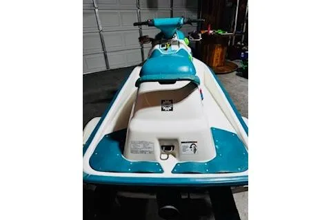 Slide: The Image of 1994 Sea-Doo SPX jet ski in a garage, featuring teal and white design. - 6
