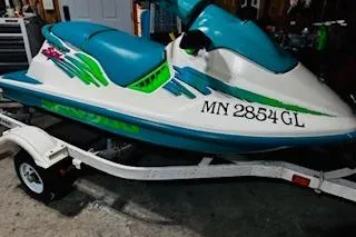 Slide: The Image of 1994 Sea-Doo SPX jet ski on trailer, teal and white design, registration MN 2854 GL. - 8