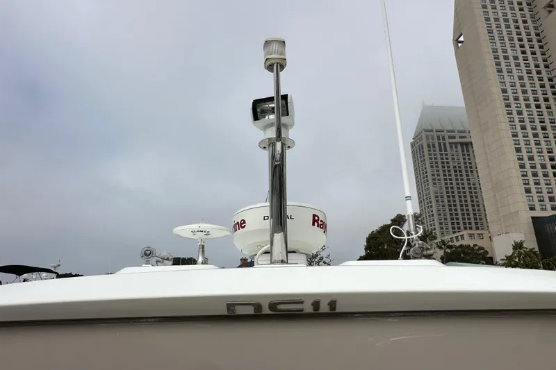 Slide: The Image of 2015 Jeanneau NC11 boat with radar equipment, cityscape background. - 11