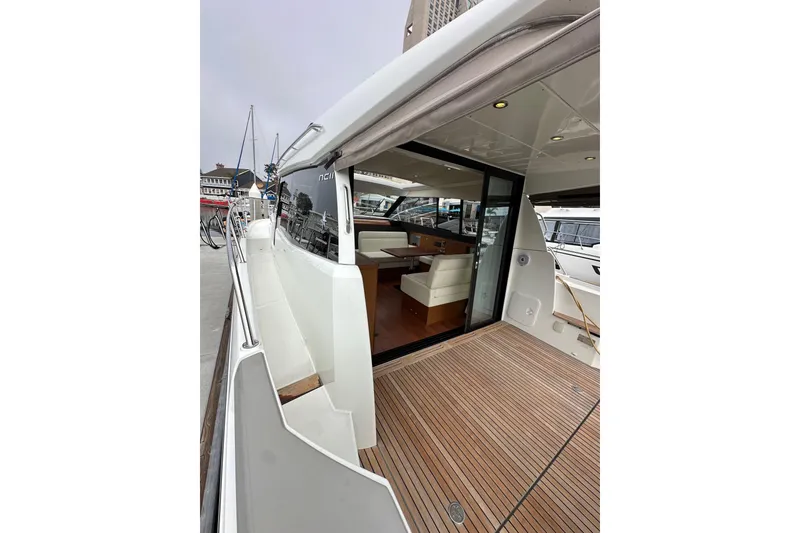 Slide: The Image of 2015 Jeanneau NC11 yacht with open deck and modern interior at dock. - 13