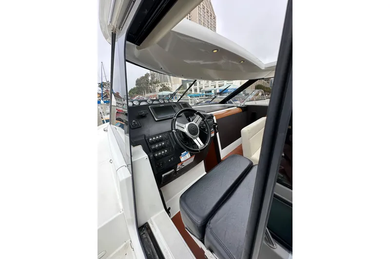 Slide: The Image of Interior view of 2015 Jeanneau NC11 boat cockpit with steering wheel and controls. - 16