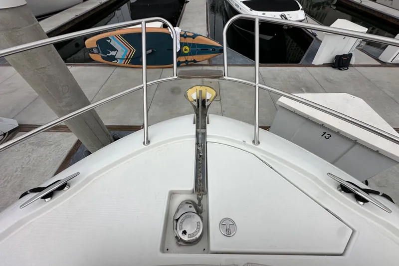 Slide: The Image of Bow view of 2015 Jeanneau NC11 yacht docked with paddleboard. - 19