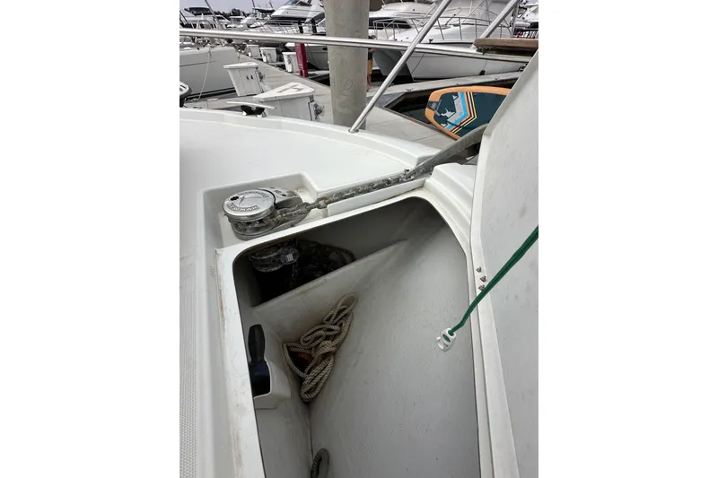 Slide: The Image of Anchor compartment of 2015 Jeanneau NC11 boat with ropes and equipment. - 20