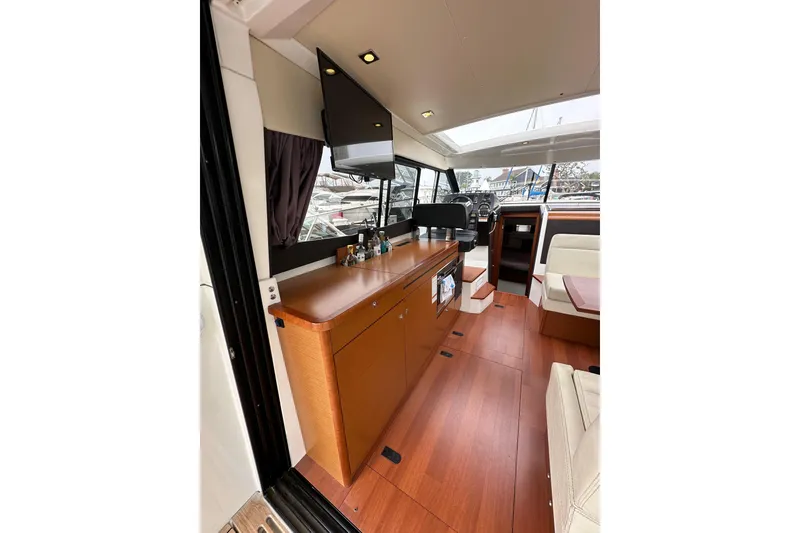 Slide: The Image of 2015 Jeanneau NC11 interior with modern wood finish and spacious layout. - 31