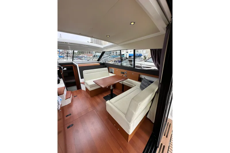Slide: The Image of 2015 Jeanneau NC11 yacht interior with elegant seating and wooden flooring. - 32