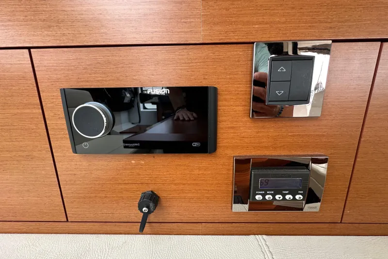 Slide: The Image of Control panel on 2015 Jeanneau NC11 boat with audio and climate controls. - 38