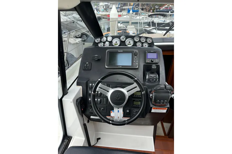 Slide: The Image of 2015 Jeanneau NC11 helm with modern navigation instruments and steering wheel. - 41
