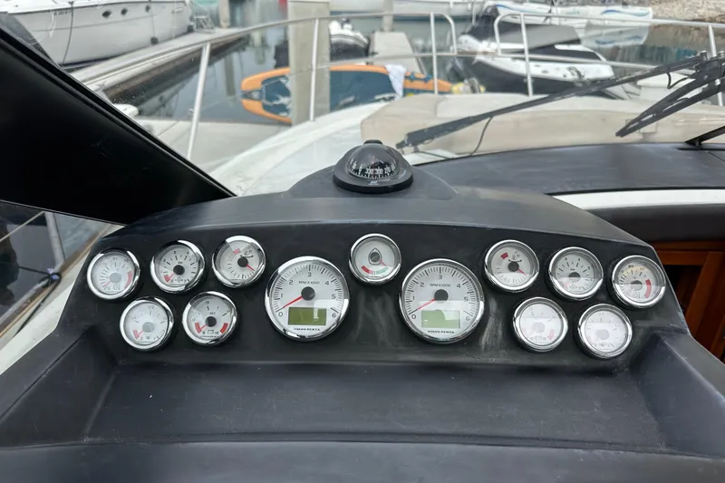 Slide: The Image of Dashboard of a 2015 Jeanneau NC11 boat with multiple gauges and compass. - 42