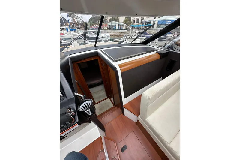 Slide: The Image of Interior view of 2015 Jeanneau NC11 boat, featuring helm and seating area. - 44