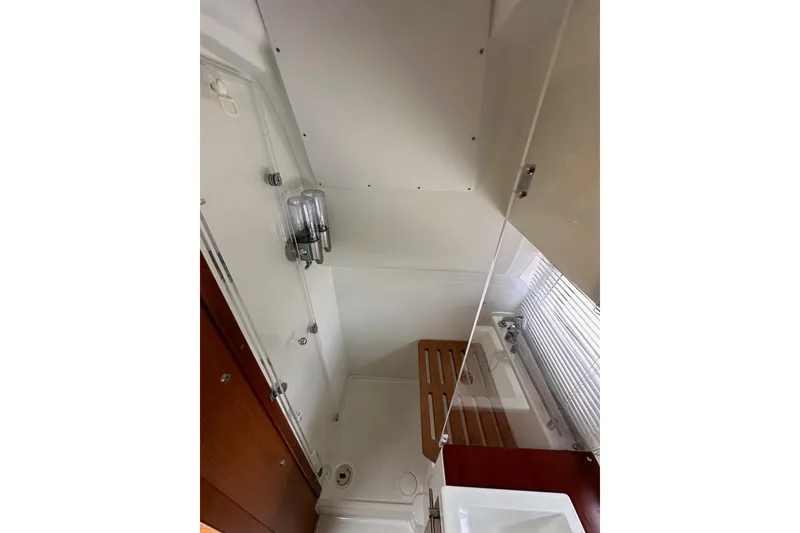 Slide: The Image of 2015 Jeanneau NC11 yacht bathroom with shower, wooden accents, and modern fixtures. - 49