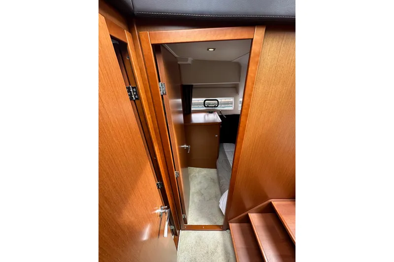 Slide: The Image of Interior view of 2015 Jeanneau NC11 boat cabin with wooden finish. - 51