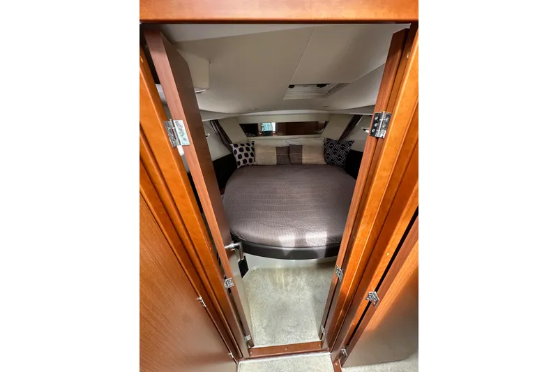 Slide: The Image of Cozy cabin interior of 2015 Jeanneau NC11 with plush bedding and wooden accents. - 56
