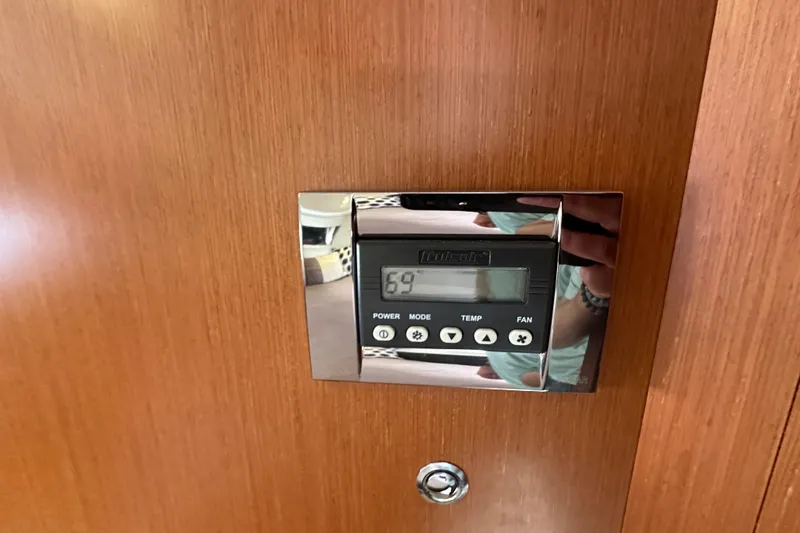 Slide: The Image of Thermostat control panel on 2015 Jeanneau NC11 boat interior. - 61