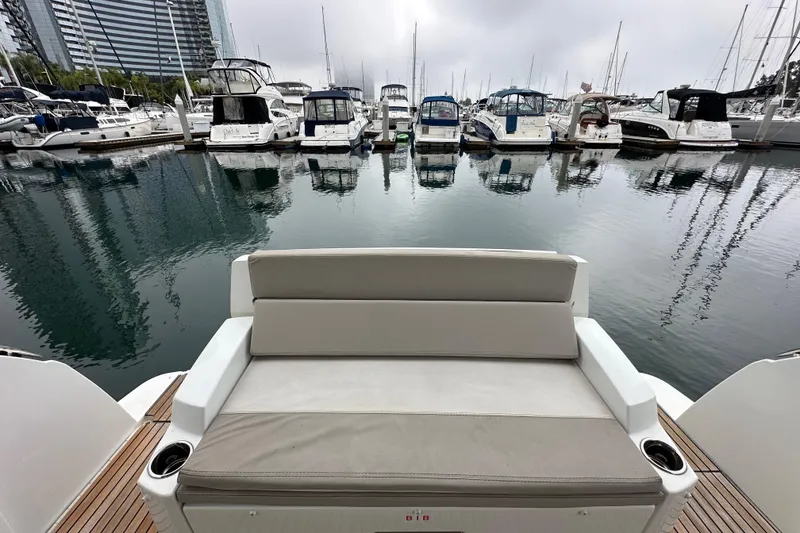 Slide: The Image of 2015 Jeanneau NC11 boat with seating, docked in a marina with other yachts. - 67