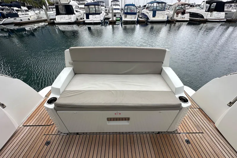 Slide: The Image of 2015 Jeanneau NC11 yacht with cushioned seating on teak deck, docked at marina. - 80