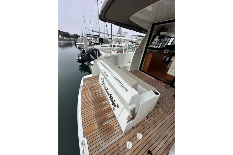 Slide: The Image of 2015 Jeanneau NC11 yacht with teak deck, docked at marina. - 85