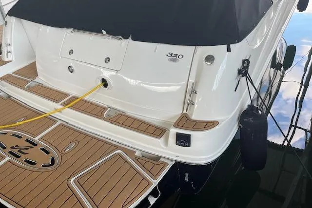 Slide: The Image of 2005 Sea Ray 320 Sundancer yacht with teak deck and mooring line. - 10