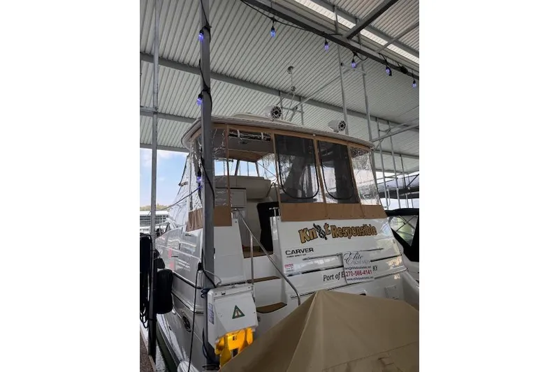 Slide: The Image of 2005 Sea Ray 320 Sundancer docked in a covered marina. - 13