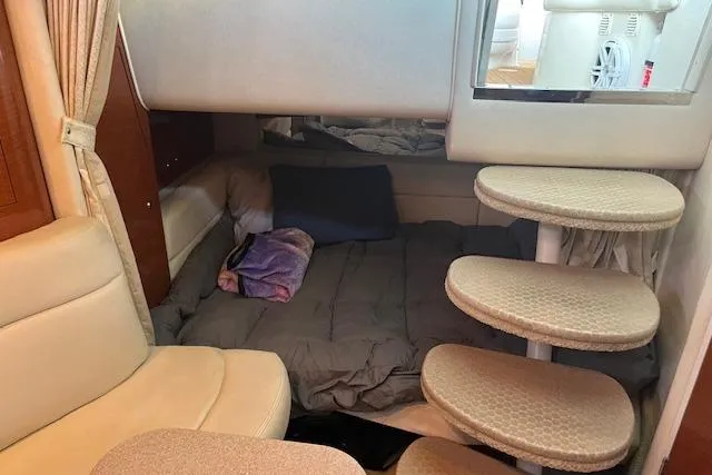 Slide: The Image of 2005 Sea Ray 320 Sundancer cabin interior with cozy sleeping area and curved steps. - 15