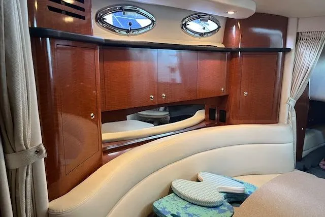 Slide: The Image of Interior of 2005 Sea Ray 320 Sundancer with wood cabinetry and porthole windows. - 16