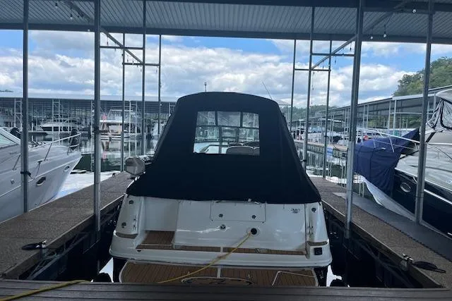 Slide: The Image of 2005 Sea Ray 320 Sundancer docked at marina under covered shelter. - 2