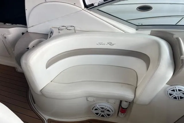 Slide: The Image of 2005 Sea Ray 320 Sundancer interior with white seating and cup holders. - 21