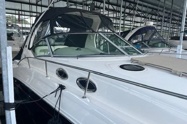 Slide: The Image of 2005 Sea Ray 320 Sundancer docked in a covered marina. - 3