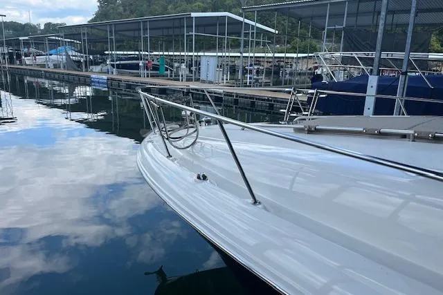 Slide: The Image of 2005 Sea Ray 320 Sundancer docked at marina, reflecting on calm water. - 5
