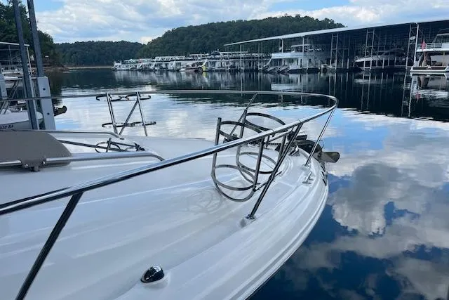 Slide: The Image of 2005 Sea Ray 320 Sundancer docked on a calm lake with scenic reflections. - 6