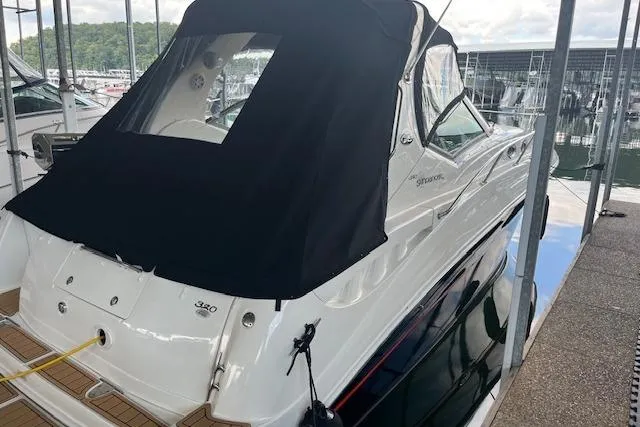 Slide: The Image of 2005 Sea Ray 320 Sundancer boat docked with black canvas cover. - 7