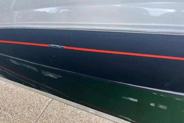 Slide: The Image of Side view of 2005 Sea Ray 320 Sundancer boat with red stripe detail. - 9