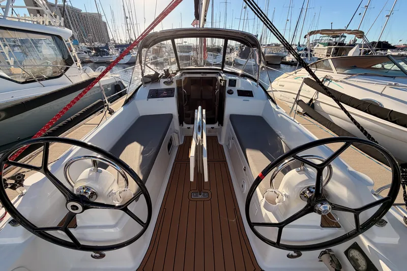 Slide: The Image of 2020 Beneteau Oceanis 30.1 yacht cockpit with dual steering wheels in marina. - 11