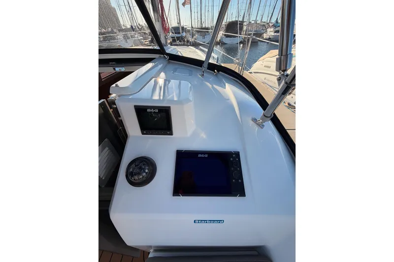 Slide: The Image of Beneteau Oceanis 30.1 cockpit with navigation equipment, 2020 model, docked at marina. - 12
