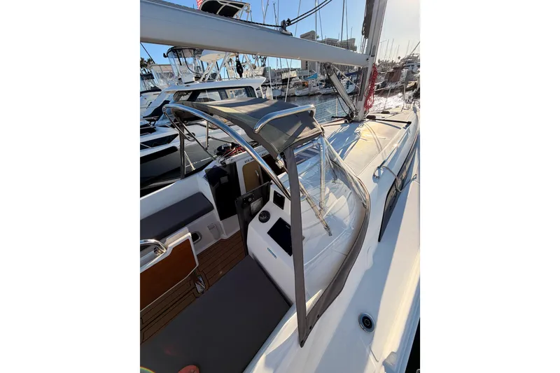 Slide: The Image of 2020 Beneteau Oceanis 30.1 sailboat docked at marina, showcasing cockpit and deck. - 13
