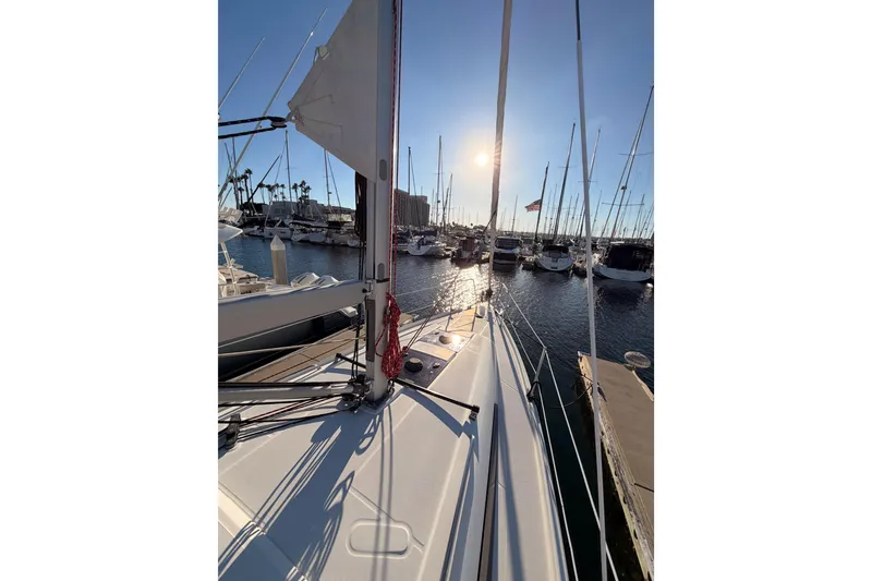 Slide: The Image of Beneteau Oceanis 30.1 sailboat docked at marina, sun setting in background, 2020 model. - 15