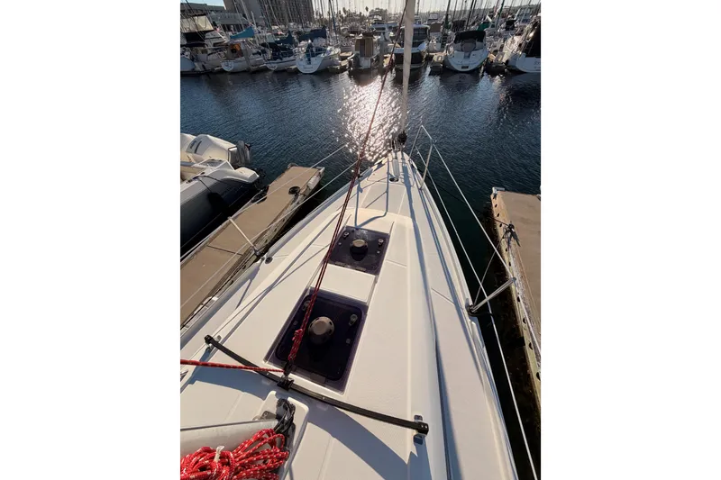 Slide: The Image of 2020 Beneteau Oceanis 30.1 sailboat docked in marina, sunlit deck view. - 16