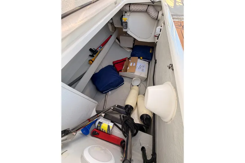 Slide: The Image of Storage compartment of a 2020 Beneteau Oceanis 30.1 sailboat with various equipment. - 24