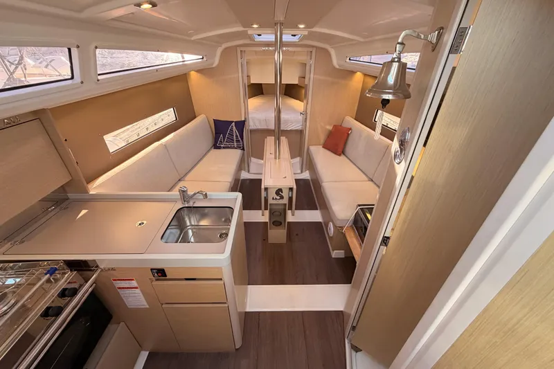 Slide: The Image of Interior of 2020 Beneteau Oceanis 30.1 yacht, featuring modern kitchen and cozy seating area. - 26