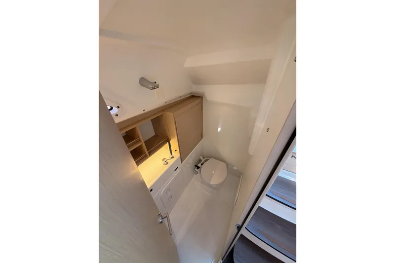 Slide: The Image of Compact bathroom in 2020 Beneteau Oceanis 30.1 yacht, featuring modern fixtures and storage. - 31