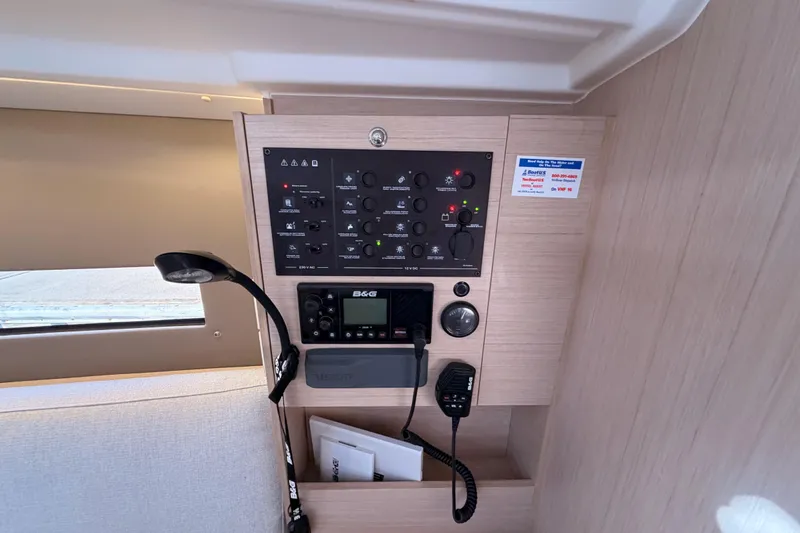 Slide: The Image of Control panel inside 2020 Beneteau Oceanis 30.1 yacht, featuring navigation and communication equipment. - 34