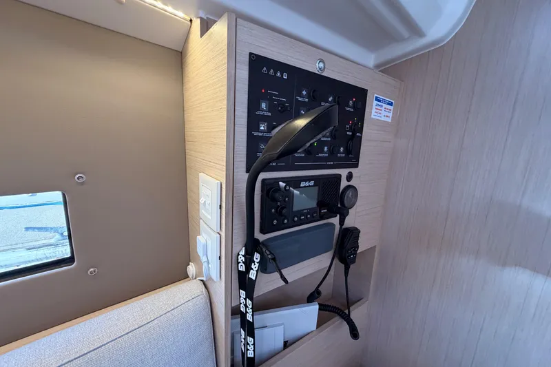 Slide: The Image of Control panel inside 2020 Beneteau Oceanis 30.1 yacht, featuring navigation and communication equipment. - 35