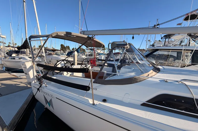 Slide: The Image of 2020 Beneteau Oceanis 30.1 sailboat docked in marina, clear blue sky. - 4