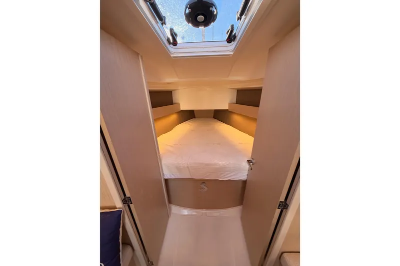 Slide: The Image of Cozy cabin interior of 2020 Beneteau Oceanis 30.1 sailboat with skylight and bed. - 40