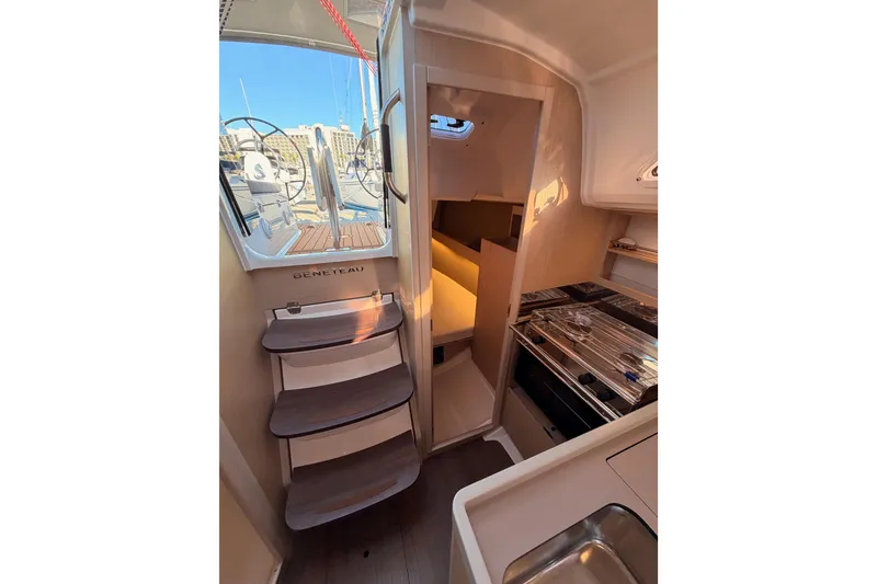 Slide: The Image of Interior view of 2020 Beneteau Oceanis 30.1 yacht, featuring stairs and compact kitchen area. - 47