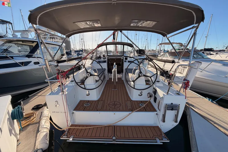 Slide: The Image of 2020 Beneteau Oceanis 30.1 sailboat docked, featuring dual steering wheels and teak deck. - 5