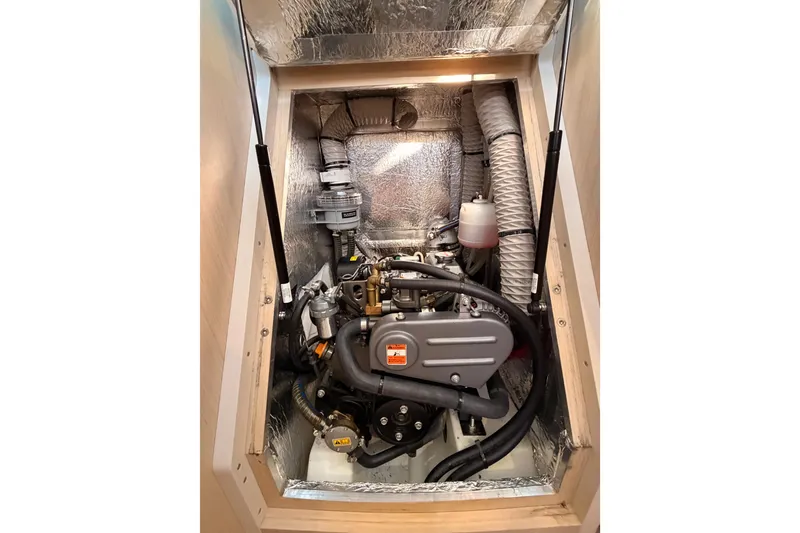 Slide: The Image of Engine compartment of a 2020 Beneteau Oceanis 30.1 sailboat, showcasing mechanical components. - 52